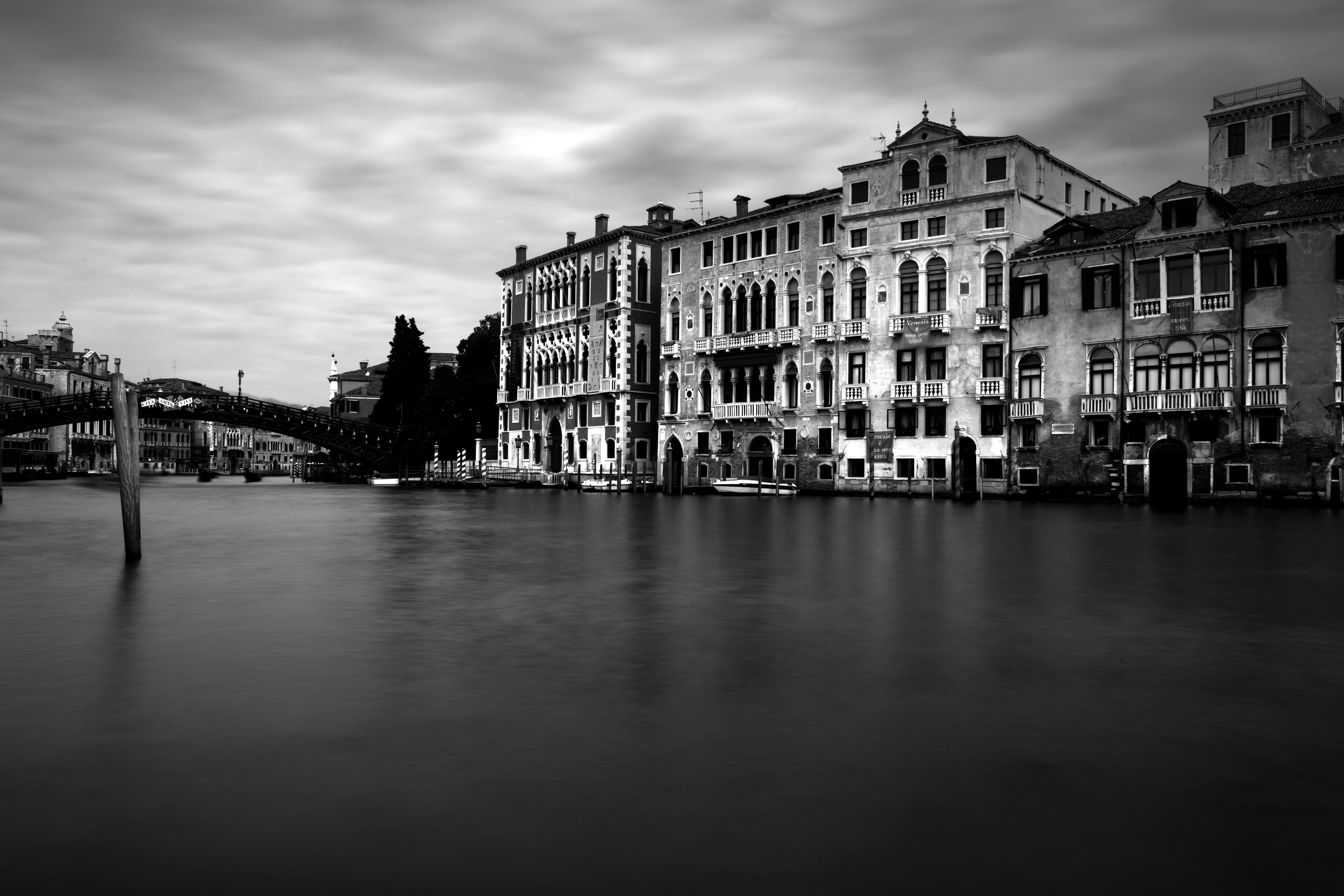 concrete buildings beside body of water